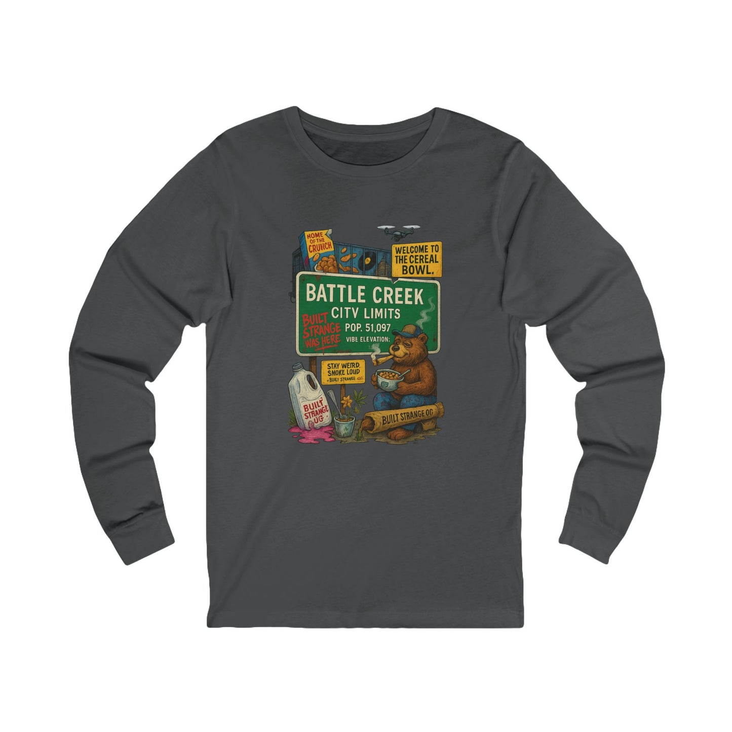 Pour up the crunch and light one up — the Battle Creek “Built Strange Was Here” long sleeve tee celebrates the cereal capital in true Built Strange fashion. Featuring the iconic bear kicking back with a bowl and a smoke, this design mixes nostalgia, humor, and that unmistakable Midwest chill.
Premium jersey long sleeve tee
Soft, breathable cotton with a relaxed fit
Full-color front print with vivid detail
Perfect for laid-back days or layered looks
Designed by Built Strange Apparel