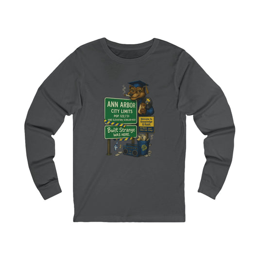 Smart smoke meets scholar energy. The Ann Arbor “Built Strange Was Here” long sleeve tee pays homage to Michigan’s high-minded city — where creativity, knowledge, and kush collide. Featuring the Built Strange grad bear posted up at city limits, this design keeps intellect and chill on the same frequency.



Premium jersey long sleeve tee

Soft, mid-weight cotton for all-day comfort

Full-color front graphic with crisp detail

Perfect for cool nights or layered streetwear looks

Designed by Built Strange App