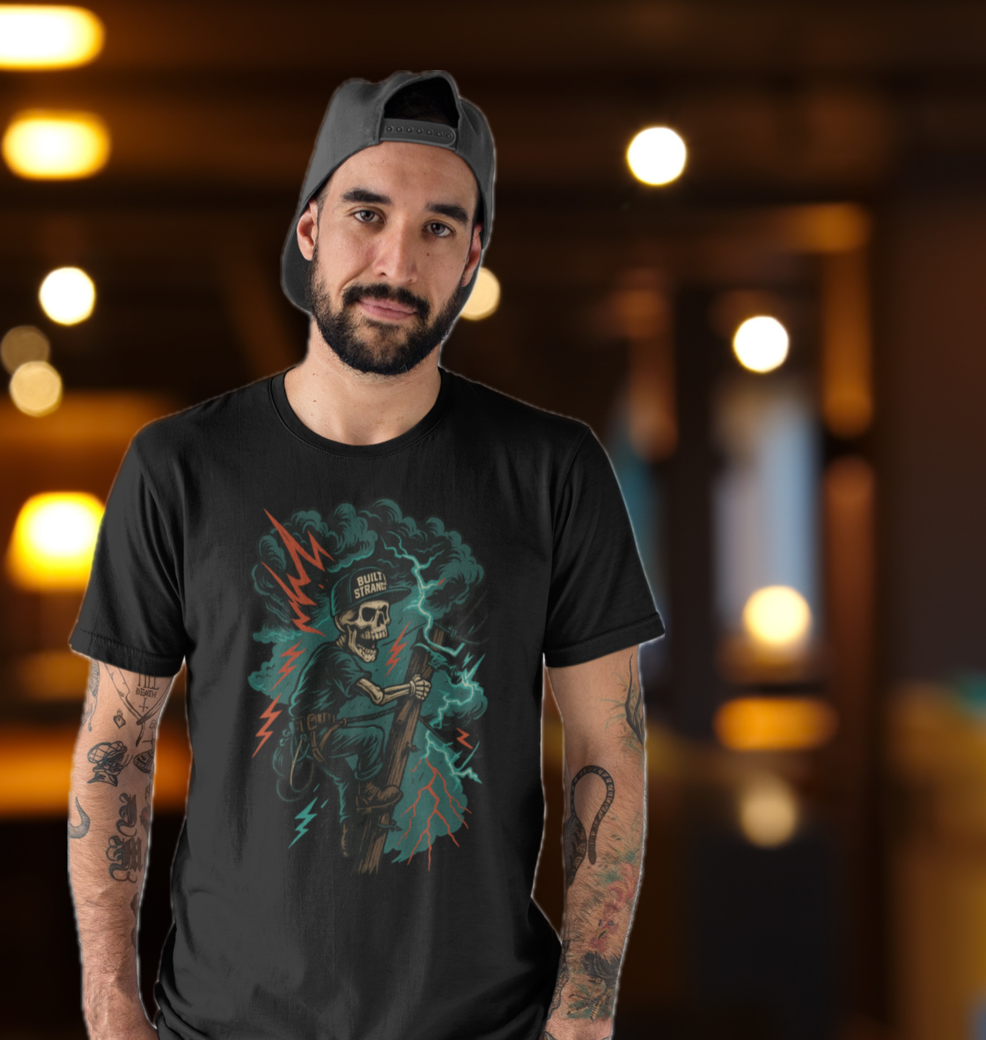 Climb into the storm. The Storm Climber graphic from Built Strange pays tribute to lineworkers who battle the elements to keep the world lit. A skeleton in full gear scales the pole under lightning-cracked skies, rocking the Built Strange cap with pride.

Perfect for tradewear, streetwear, or anyone who knows the grind doesn’t stop when the storm rolls in. Heavy ink, bold colors, and jobsite grit — this is more than a shirt, it’s a badge of honor.
